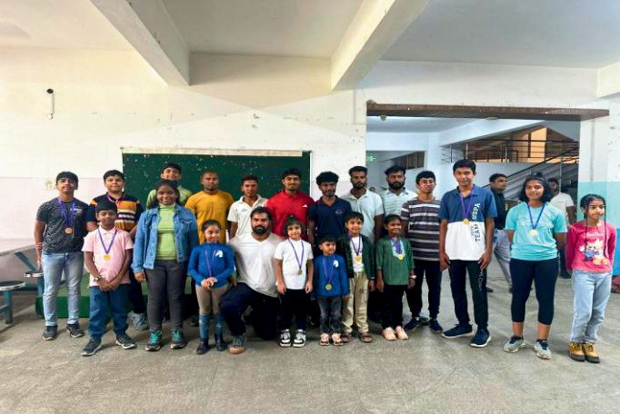 Group of students holding medals indoors after a session